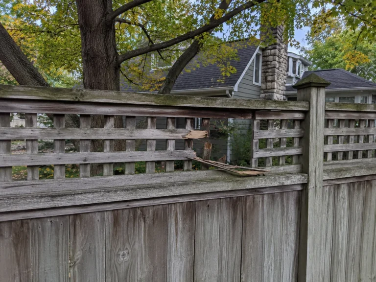Detailed view of aged decorative lattice wood fence in Cedar Rapids, Iowa