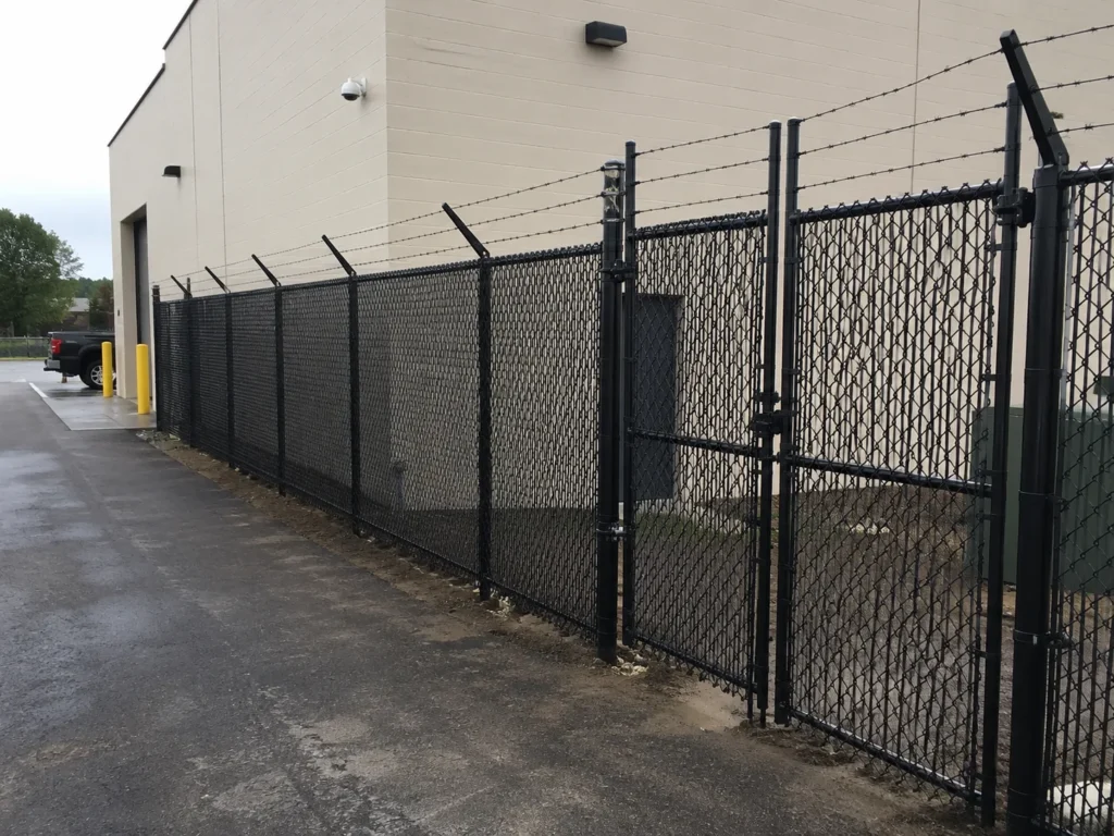 Detailed view of black chain link security fence with barbed wire in Cedar Rapids, Iowa
