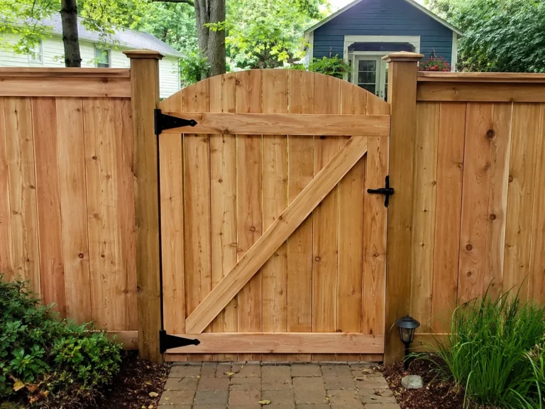 Residential cedar arched garden gate photographed in Cedar Rapids, Iowa