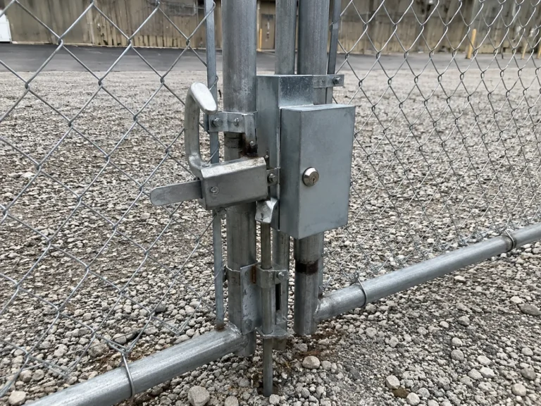 Residential chain link gate latch and lock hardware photographed in Mount Vernon, Iowa