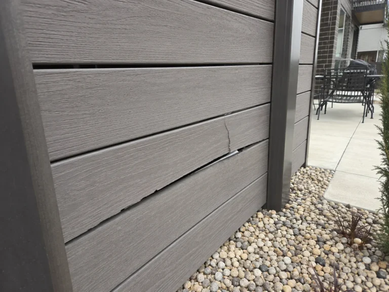 damaged gray composite privacy fence board in Cedar Rapids, Iowa