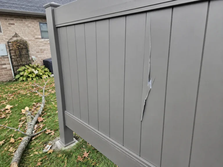 Cedar Rapids, Iowa view of damaged gray privacy fence panel