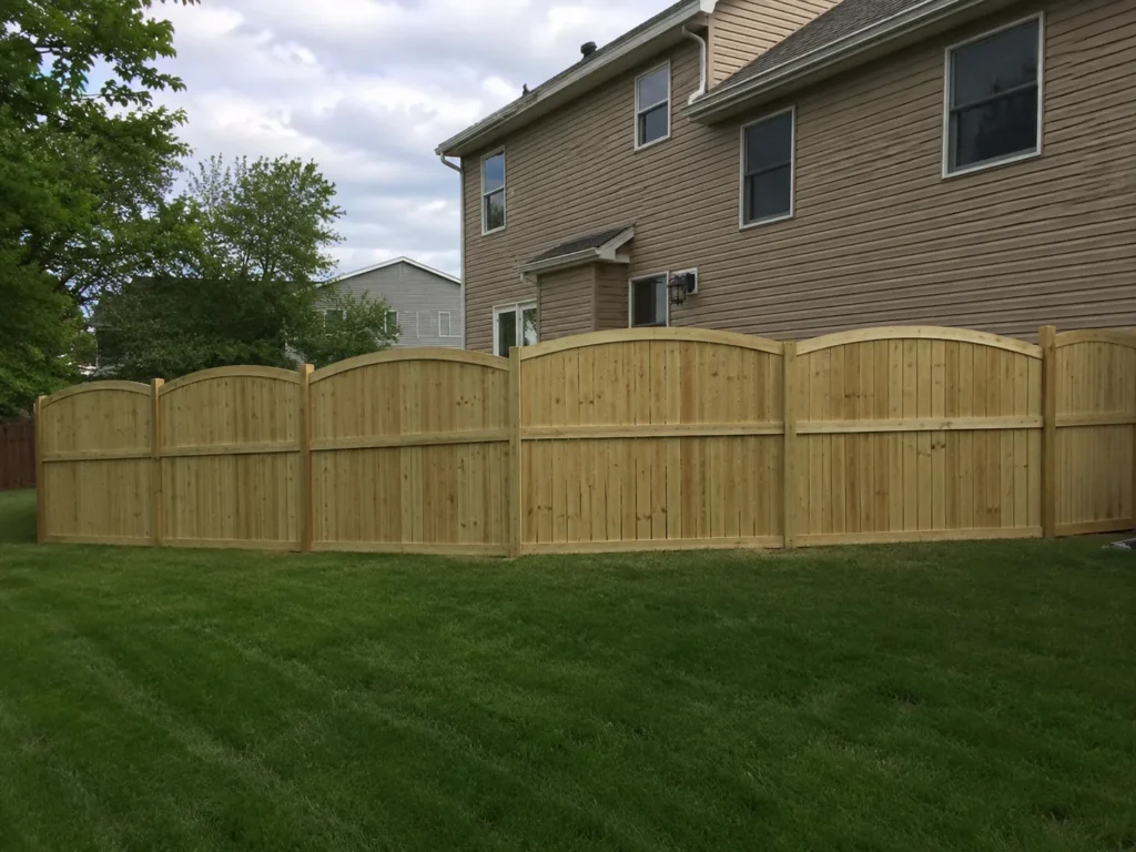 decorative scalloped cedar privacy fence shown at a property in Cedar Rapids, Iowa