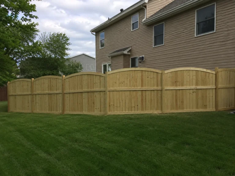 decorative scalloped cedar privacy fence shown at a property in Cedar Rapids, Iowa