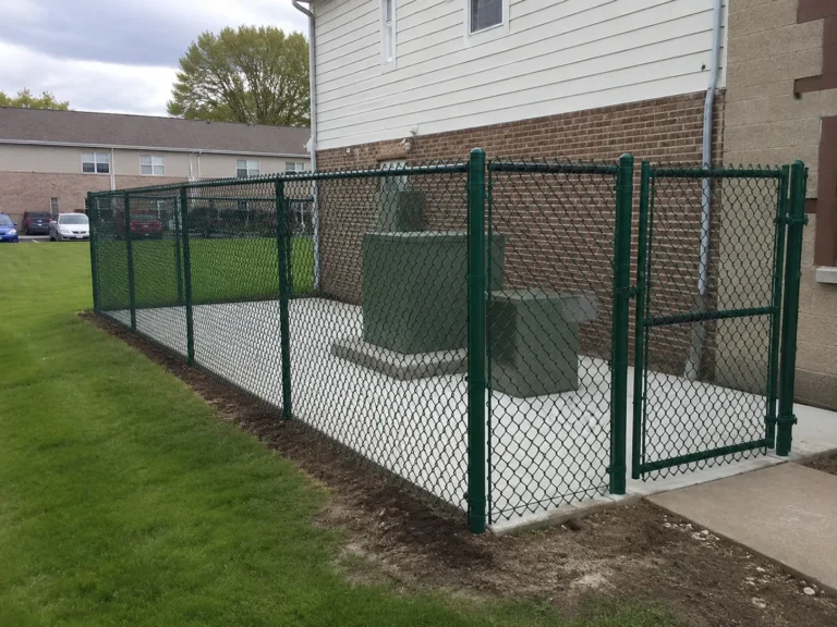 Mount Vernon, Iowa fence project showing green chain link utility enclosure