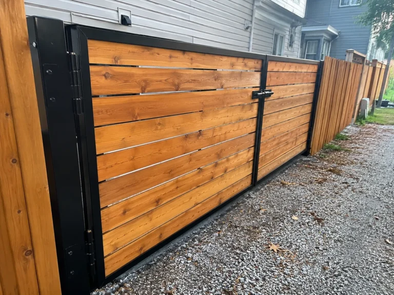 Close view of horizontal cedar privacy gate with black steel frame in Ely, Iowa