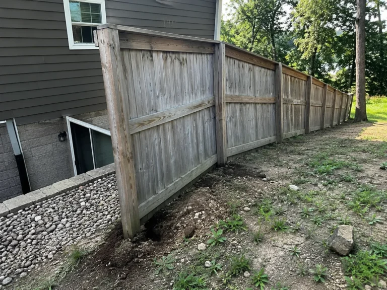 leaning weathered wood privacy fence in Marion, Iowa