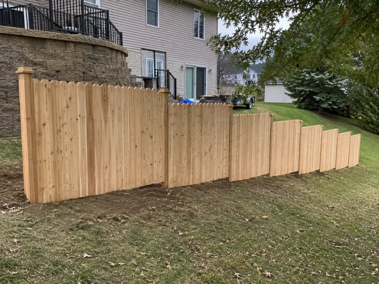 Ely, Iowa view of stepped wood privacy fence on a sloped yard