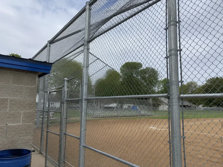tall chain link backstop and security fence shown at a property in Cedar Rapids, Iowa