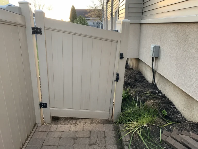 tan vinyl side yard gate shown at a property in Cedar Rapids, Iowa