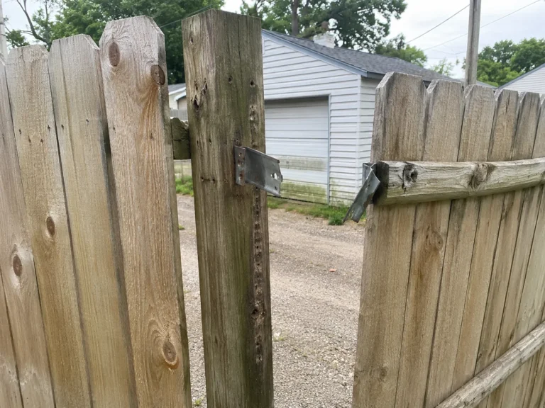 weathered wood privacy gate hinge repair at an Eastern Iowa property in Cedar Rapids