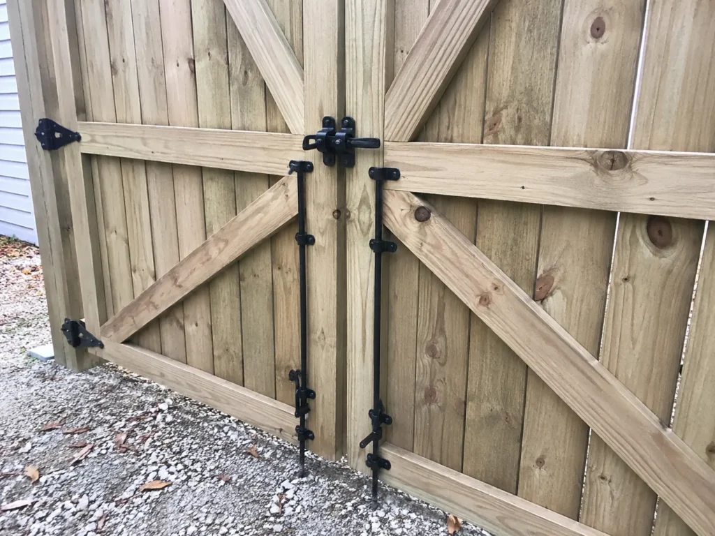 Residential wood double privacy gate hardware photographed in Fairfax, Iowa